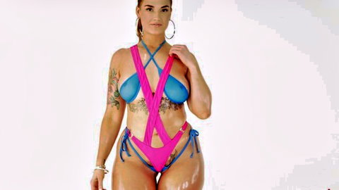 Curvy tattooed PAWG in skimpy pink blue swimsuit flaunting huge tits and fat oiled ass