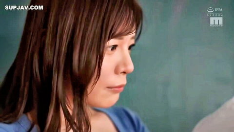 Seductive Japanese woman with long brown hair in blue top profile view from JAV