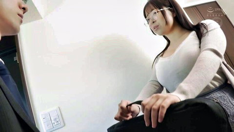 Busty Japanese babe in glasses gropes suited man's cock bulge through pants