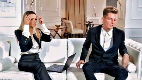 Shalina Devine as stressed horny boss in suit with male colleague on sofa