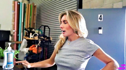 Blonde Bonnie Blue in tight grey tee, teasing in gym setting