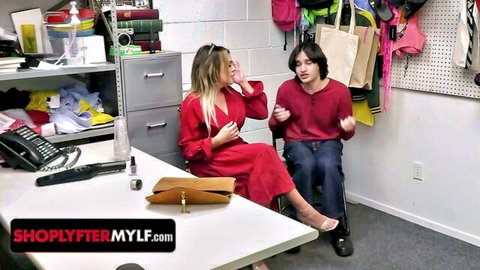 Busty blonde MILF in red dress interrogates young shoplifter in office
