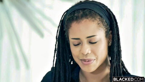 Kira Noir with dreadlocks and headscarf smiling seductively for Blacked