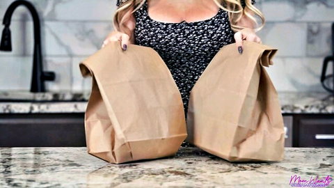 Blonde MILF holding bags in kitchen, teasing for creampie in panties