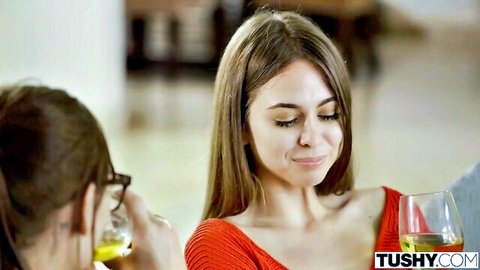Riley Reid in red top sipping wine at intimate dinner scene