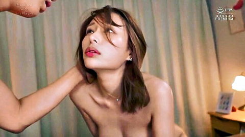 Seductive Asian woman topless with hand gripping neck in intimate JAV scene