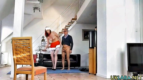 Busty MILF in stockings and Santa hat poses nude with mature man