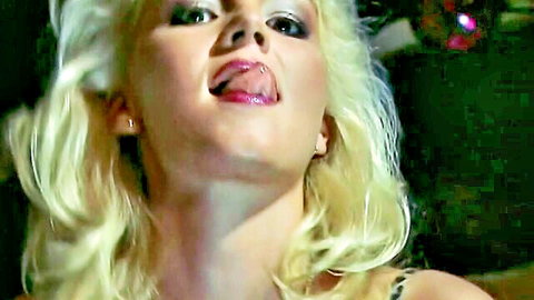 Dolly Golden teases with pierced tongue close-up, seductive blonde stare