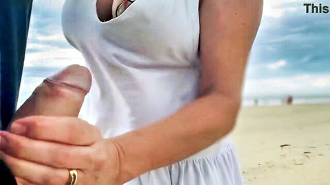 Busty MILF Jane R strokes stranger's cock on crowded beach
