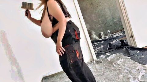 Horny MILF with big natural tits in overalls, holding paint roller