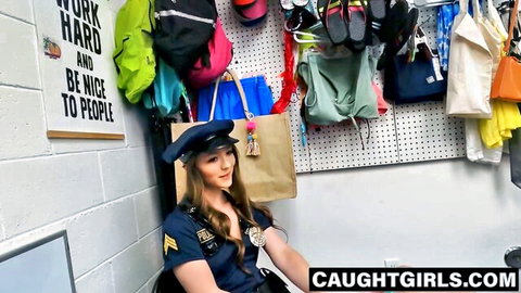 Sexy brunette police officer in tight uniform smiling with cleavage in locker room