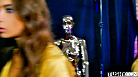 Kelly Collins seductive pose with silver robot in yellow top TUSHY
