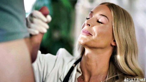 Blonde in suit gazes ecstatically at gloved man's throbbing cock with syringe tip