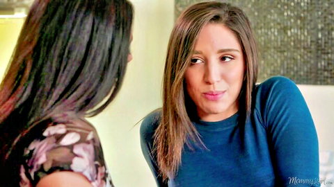 Brunette MILF in blue sweater talks intimately with young beauty before steamy lesbian action