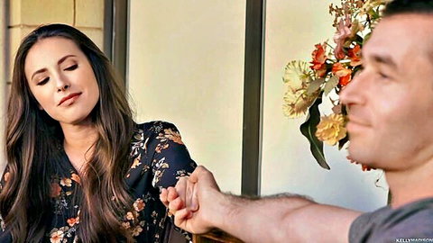Casey Calvert in intimate hand-holding moment with lover in floral dress