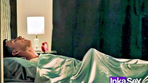 Sexy Asian man lying naked in bed under green silk sheets moaning seductively