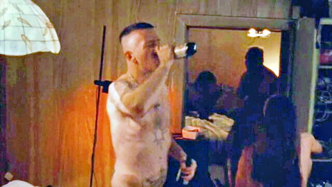Bald tattooed man nude in intense orgy scene from mainstream film
