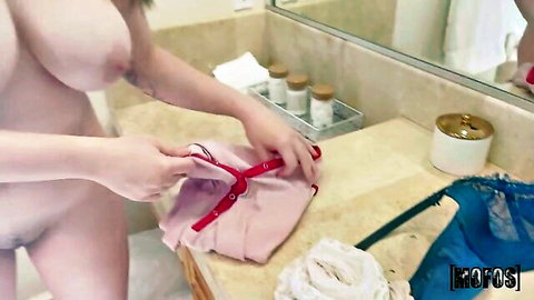 Alyx Star nude in bathroom holding pink lingerie, big tits exposed