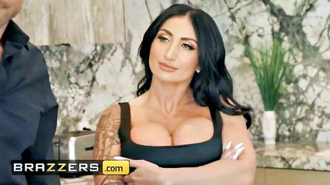 Busty brunette with massive cleavage in tight black top teases seductively in kitchen