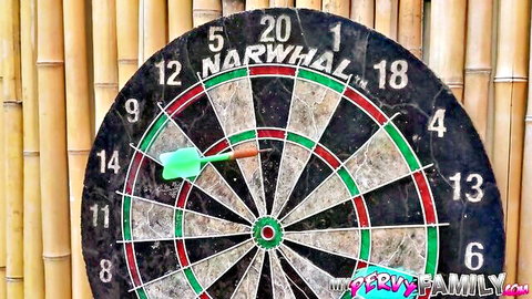 Green dart piercing 20 section on worn Narwhal dartboard with bamboo backdrop