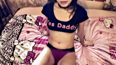 Asian woman in 'Yes Daddy' crop top, choker, and purple panties posing seductively