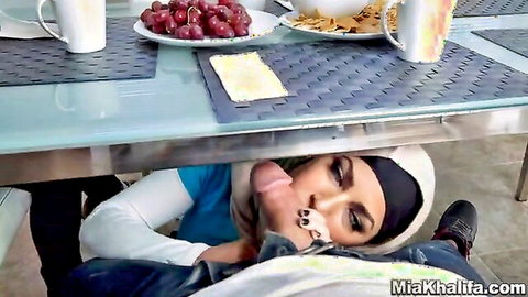 Arab woman in hijab under table giving blowjob in hot threesome