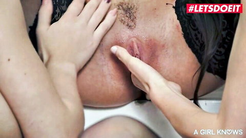 Lesbian fingering close-up: woman touches hairy pussy intimately