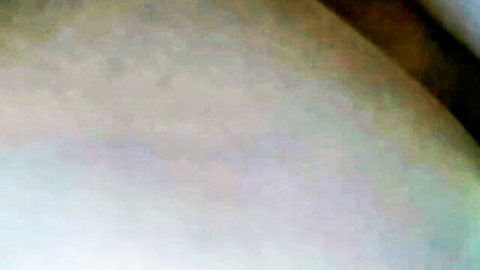 Blurry pixelated closeup of indistinct skin tones in low quality adult video