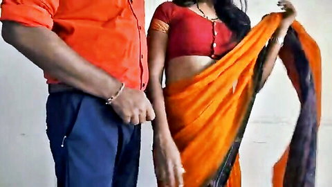 Curvy Indian bhabhi in red blouse and orange saree showing cleavage and curves