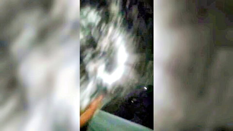 Blurry dark scene with hand reaching toward glowing hole