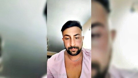Bearded man with dark hair in open pink shirt, seductive gaze