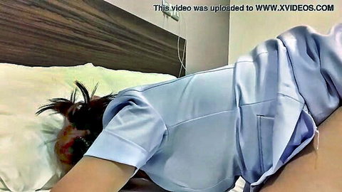 Cute plump Thai nurse in uniform exposing tight ass on bed