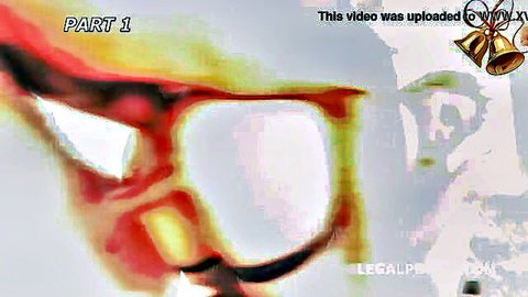 Kira Thorn close-up with red-tinted glasses in Xmas orgy thumbnail