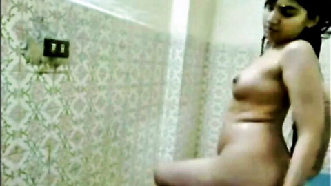 Nude Indian woman posing solo in bathroom, curvy body exposed