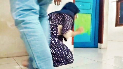 Man in jeans grabs hijabi woman in polka-dot dress from behind in amateur doggy style tease
