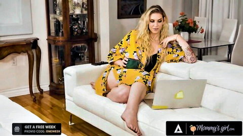 Tattooed blonde MILF stepmom in open yellow robe, black lingerie, laptop tease