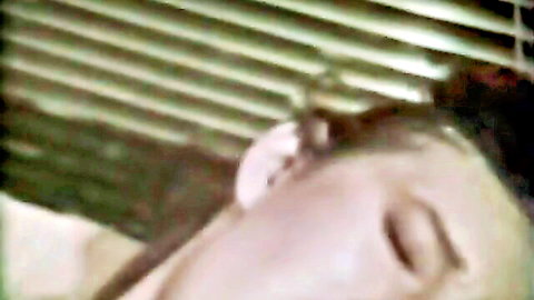 Vintage porn star Carol in ecstasy close-up, eyes closed with cleavage