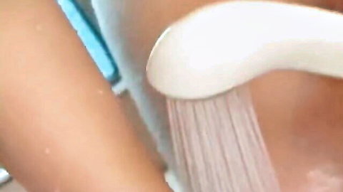 Thai teen's huge wet tits under shower stream closeup