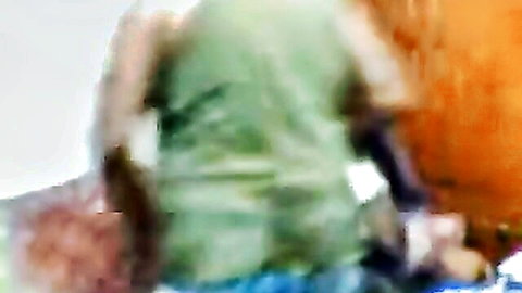 Arab model Nik in green top and orange bottoms from behind