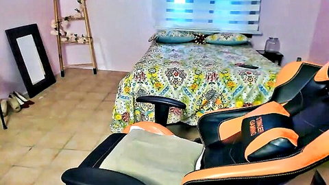 Empty pink amateur bedroom with floral bed, orange gamer chair, high heels and mirror