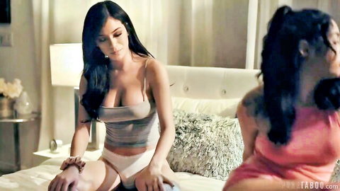 Savannah Sixx in gray crop top and white shorts on bed, seductive pose