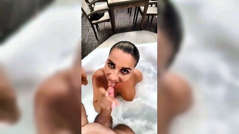 Nude brunette in bubble bath seductively sucks wet finger like cock tease
