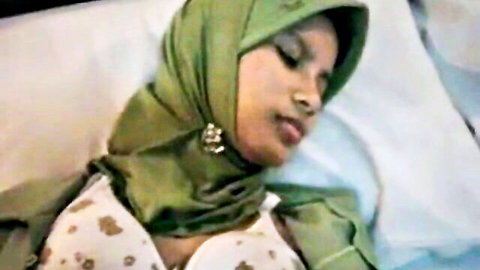 Arab-Asian babe in green hijab and lacy bra teasing on bed