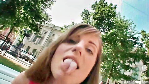 Adorable brunette teen sticks tongue out teasingly outdoors