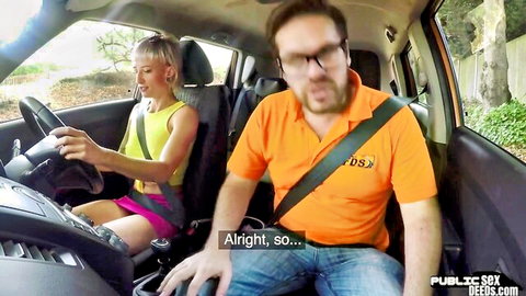 Blonde woman in yellow tank top and pink skirt drives car with male passenger talking in amateur public video