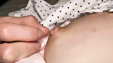 Hand exposing small Asian nipple in polka-dot dress, amateur JAV close-up