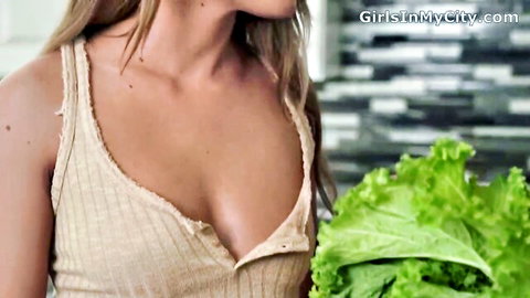 Blonde MILF stepmom in deep cleavage tank top holding lettuce