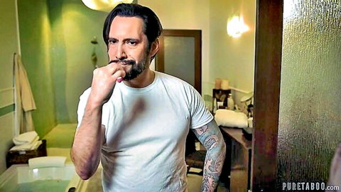 Tattooed man brushing teeth in bathroom, Victoria Voxxx scene