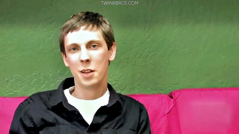 Derick Jett in casual interview on pink couch, young twink model