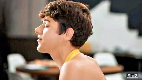 Joey Mills shirtless in yellow collar, curly hair side profile